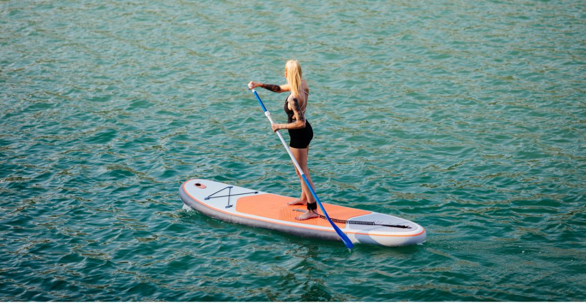 Lady paddle boarding in the sea