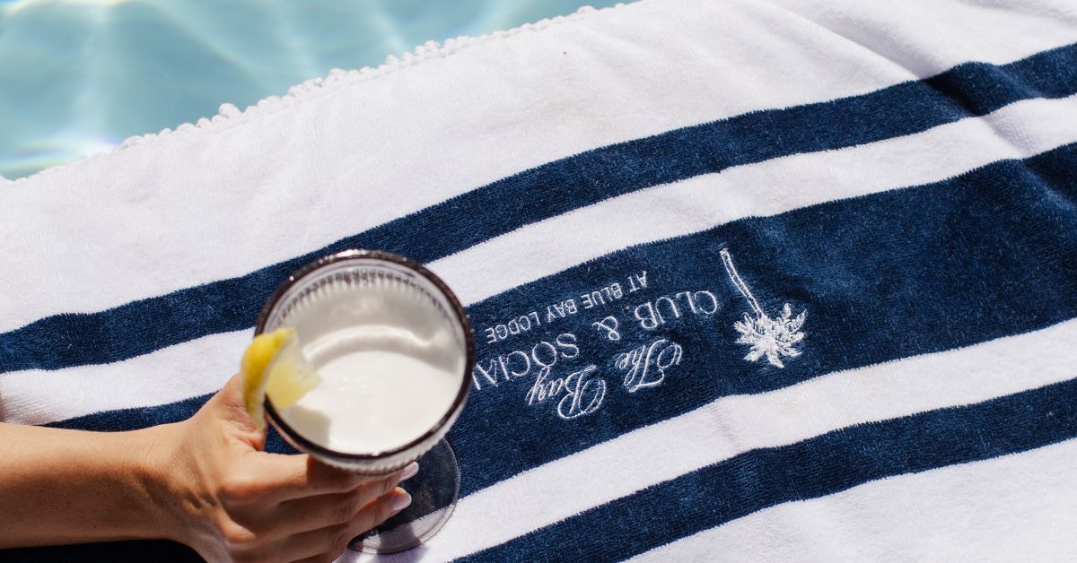 Close up of a cocktail on a beach towel