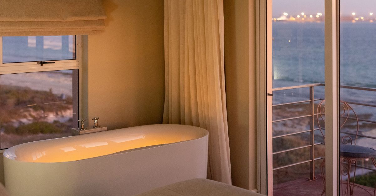 Romantic candle lit bath with ocean view at Blue Bay Lodge