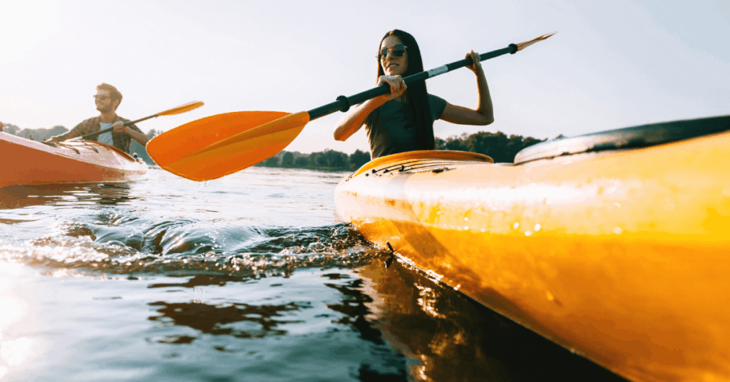A couple kayaking on the ocean while enjoying a romantic getaway on the West Coast