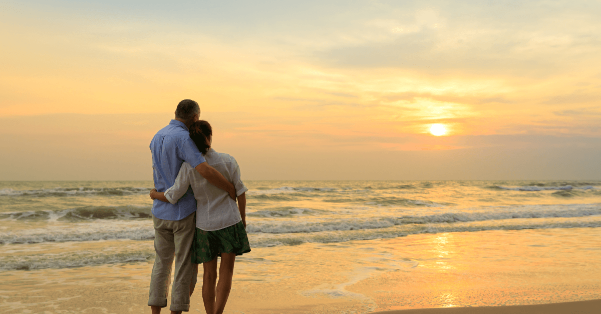 Two people enjoying a couple getaway in the western cape and admiring the sunset from the beach on the West Coast