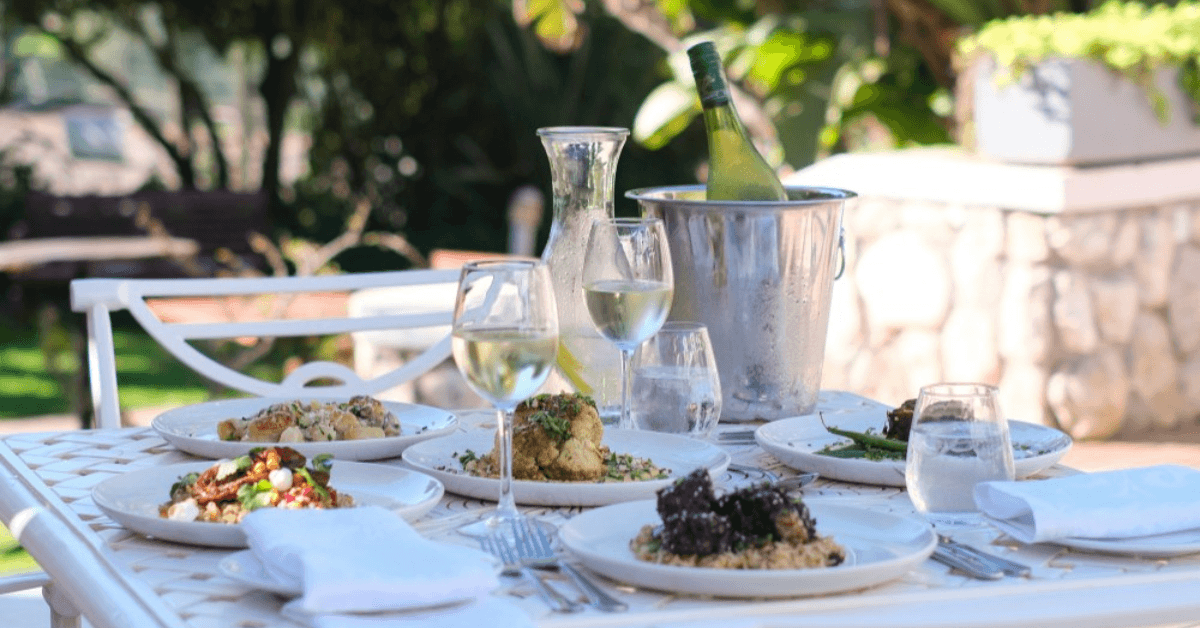 Outdoor function venue with catered meal on a table at Blue Bay Lodge 