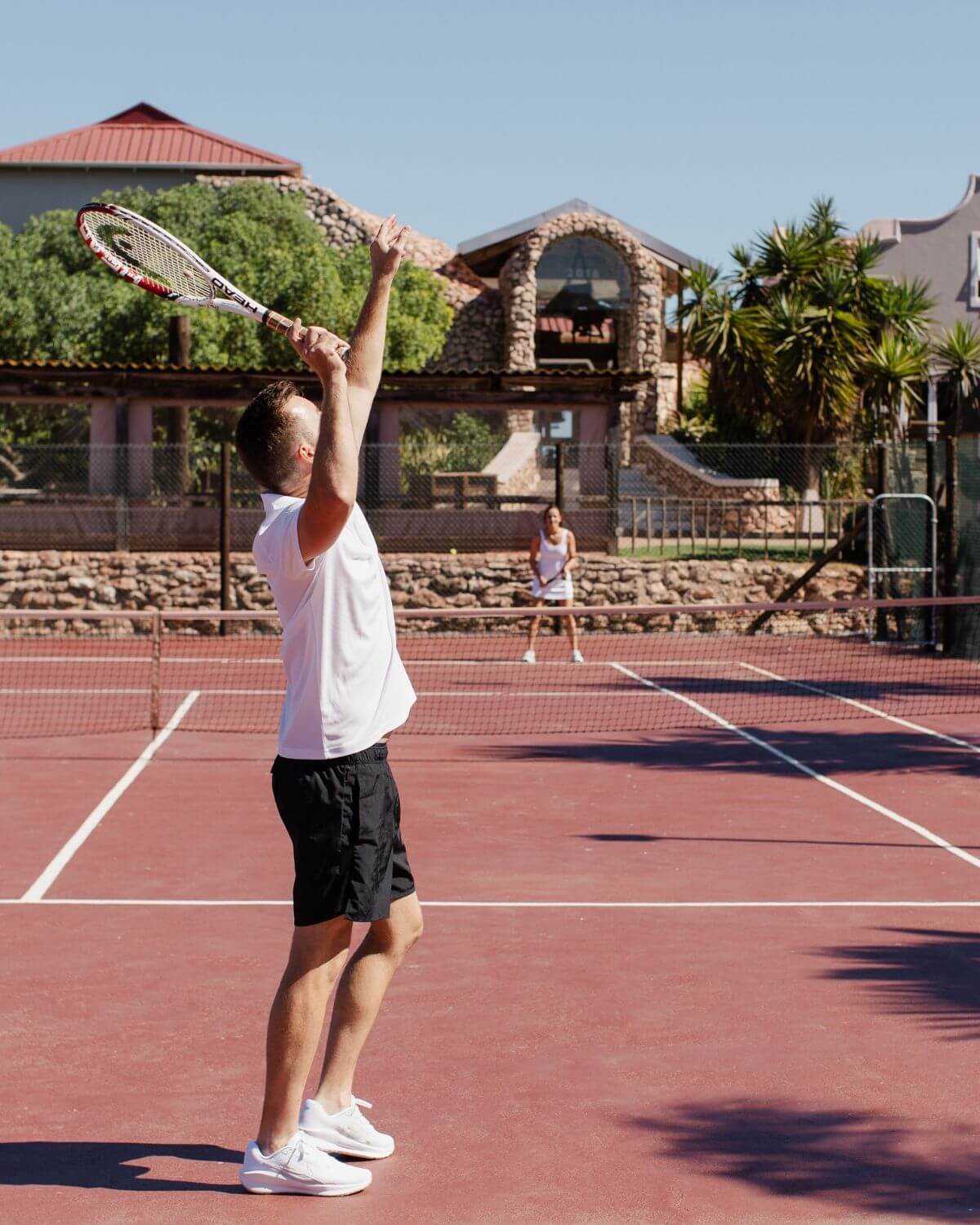 Couple playing tennis