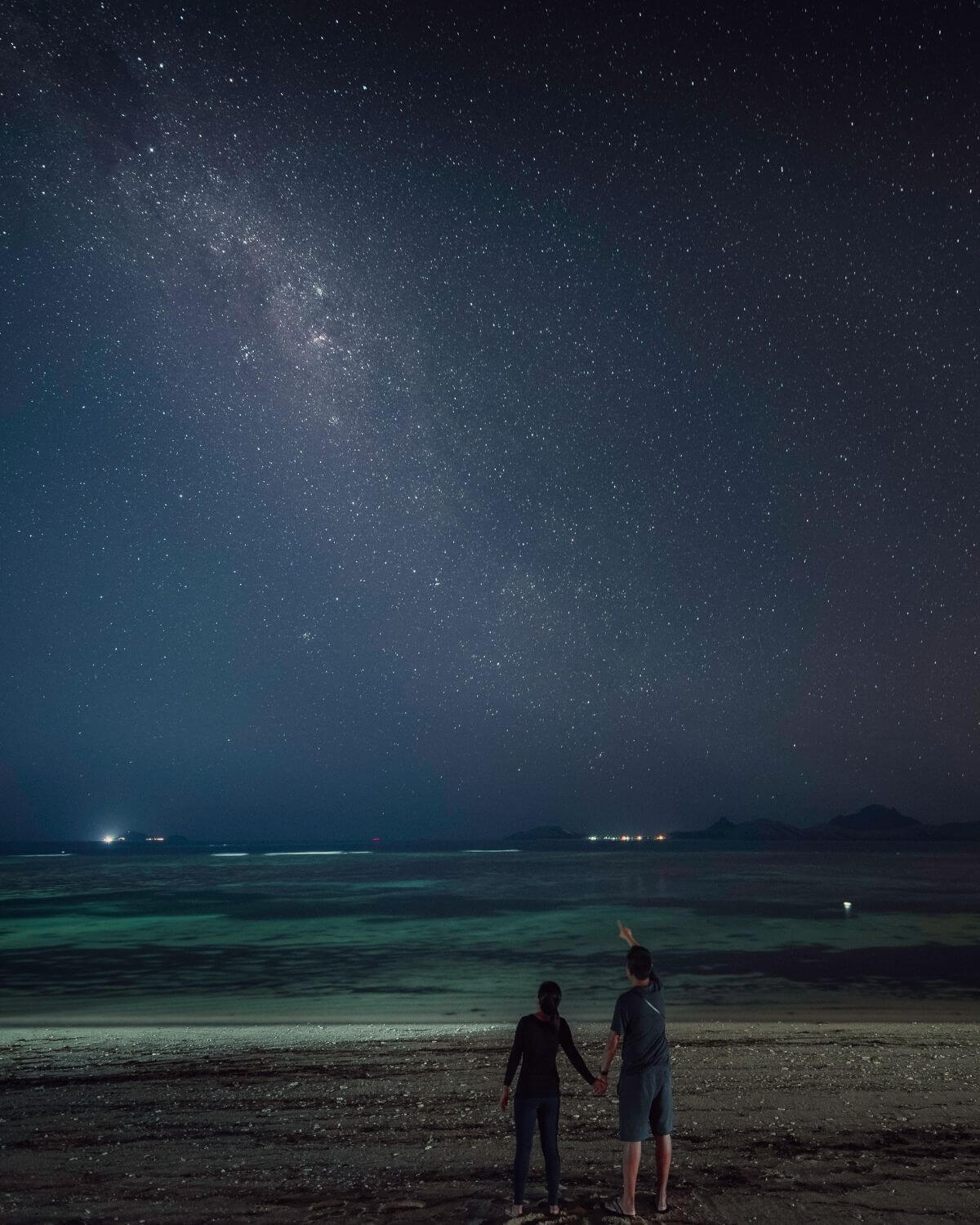 Couple stargazing at the beach