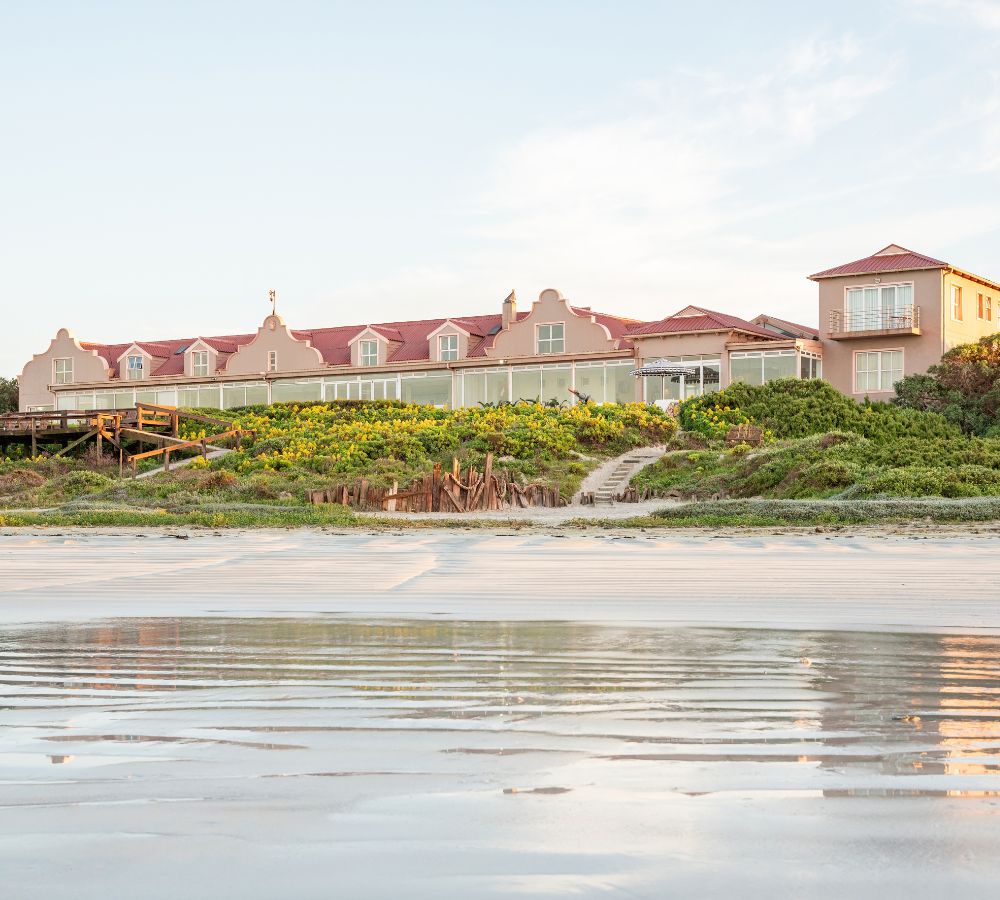 A view of Blue Bay Lodge with the reflection on the sand